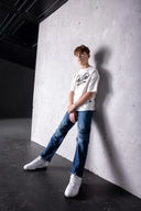 Model wearing white script t-shirt and jeans