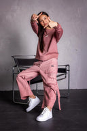 Model wearing matching Dusty Rose sweatshirt and cargo pants